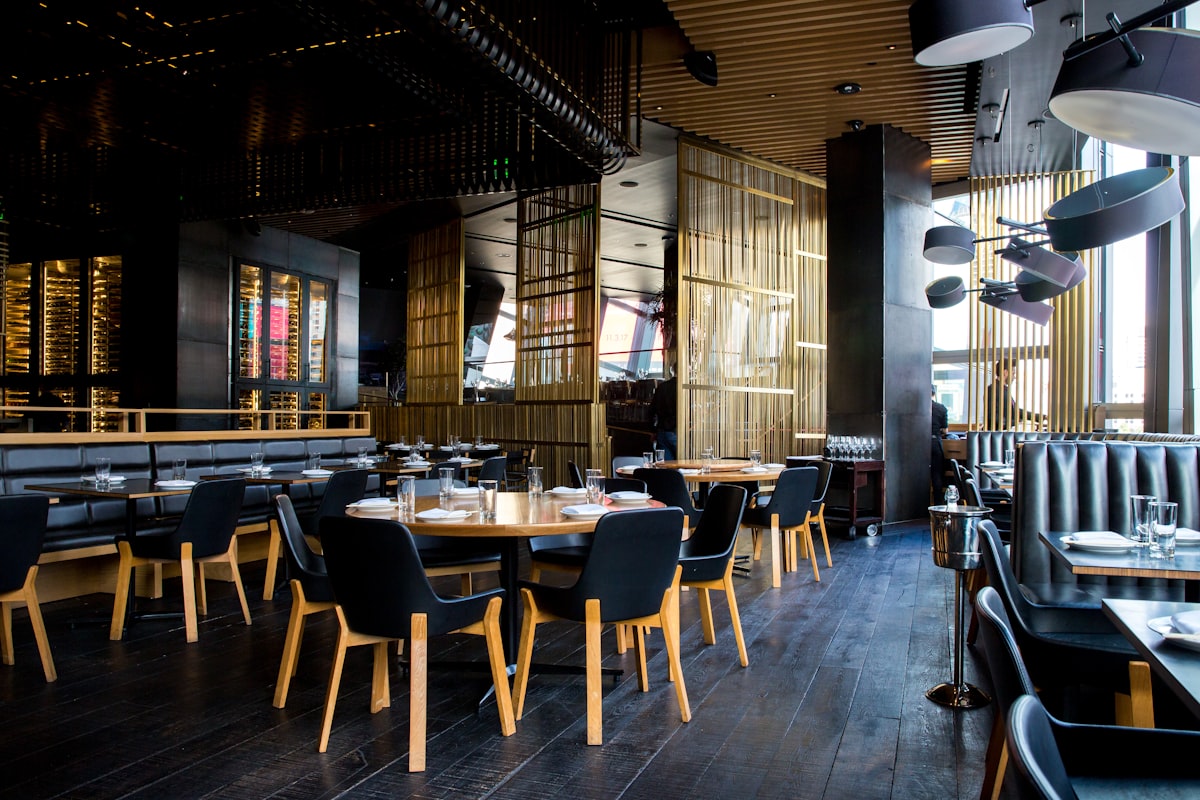 Warm, dimly lit dining room at Ember & Oak with gold accents and hearth glow