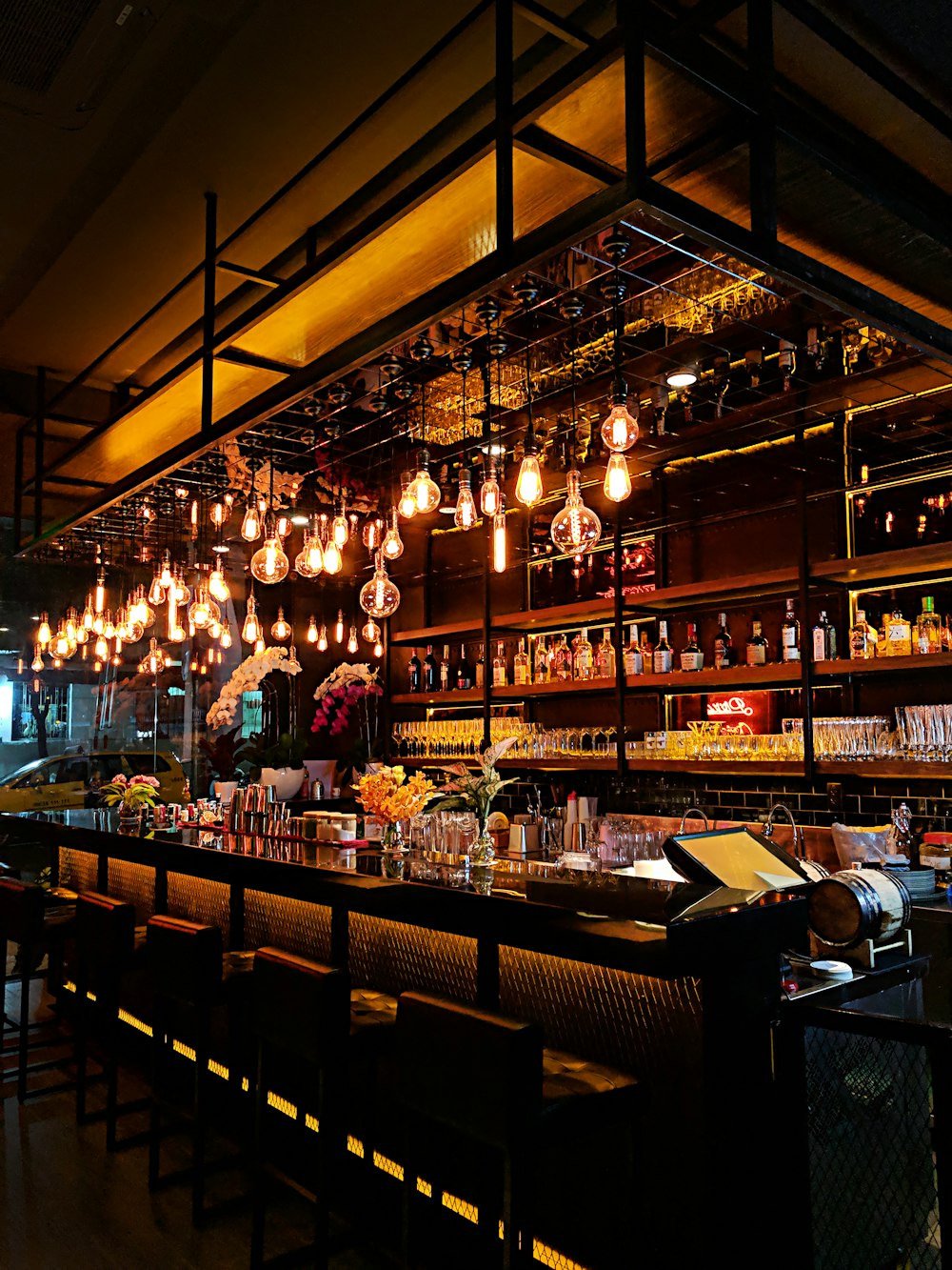 Bar area strung with warm edison bulbs and glassware