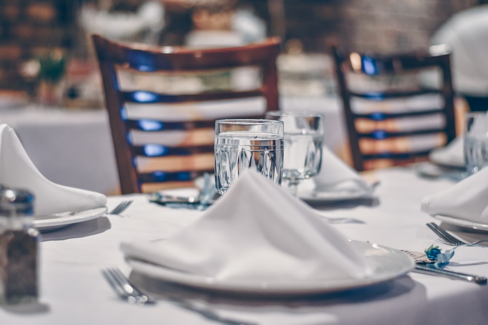 Close-up of an elegant table setting with linen napkins and water glasses