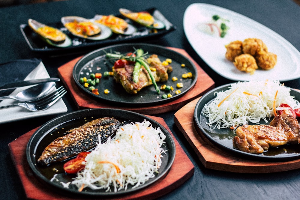 Assortment of small plates served on dark ceramic dishes