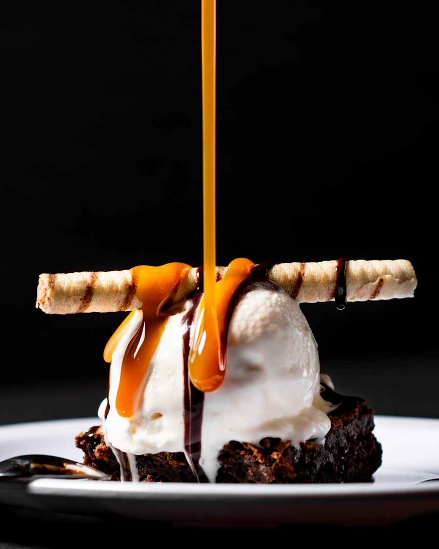 Chocolate brownie sundae with caramel being poured over it